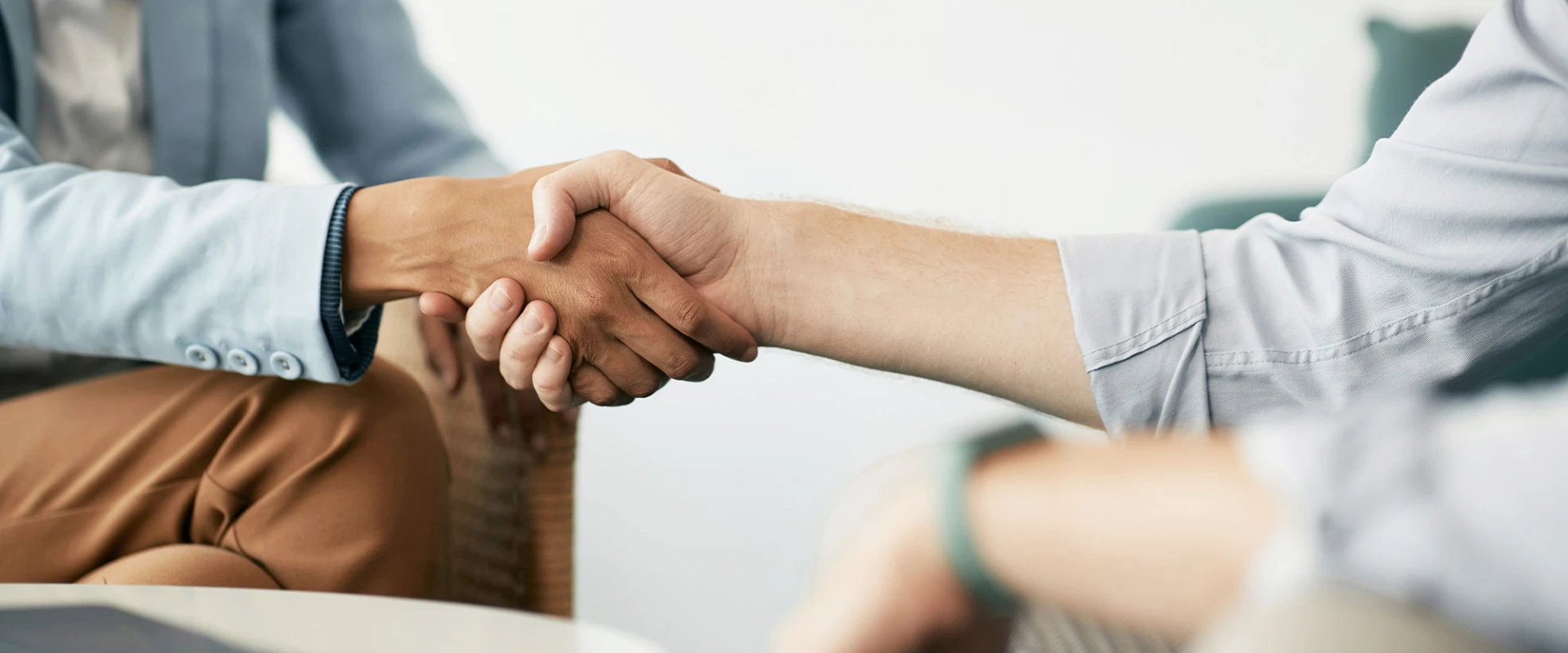 Two people shaking hands in an office