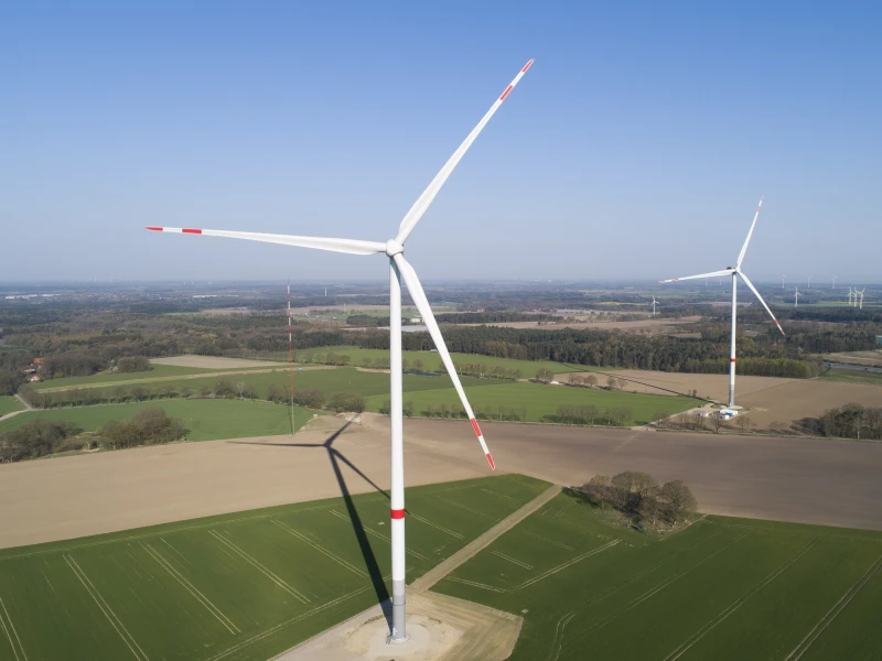 Aerial view of three wind turbines in a rural area