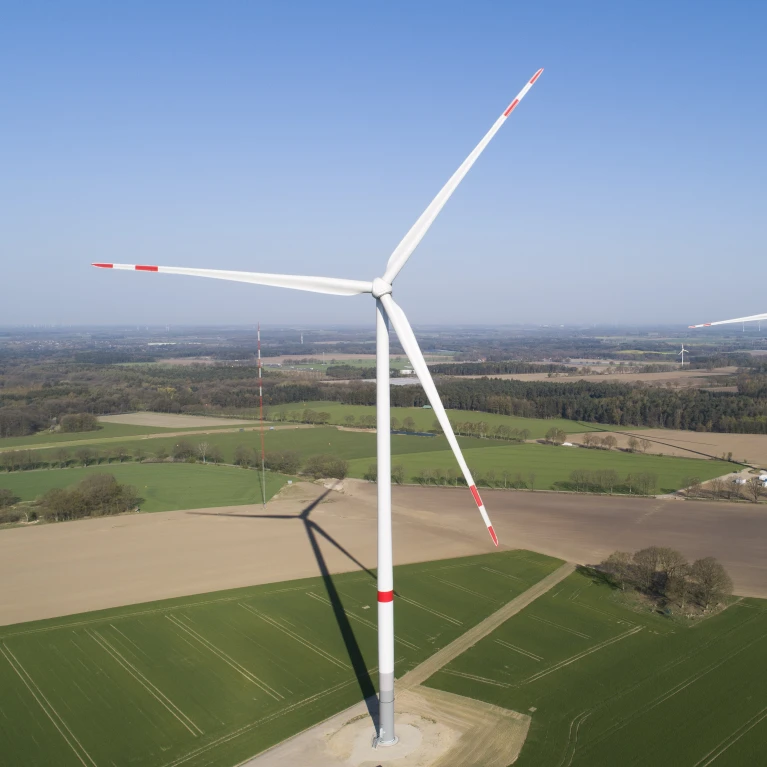 Aerial view of three wind turbines in a rural area