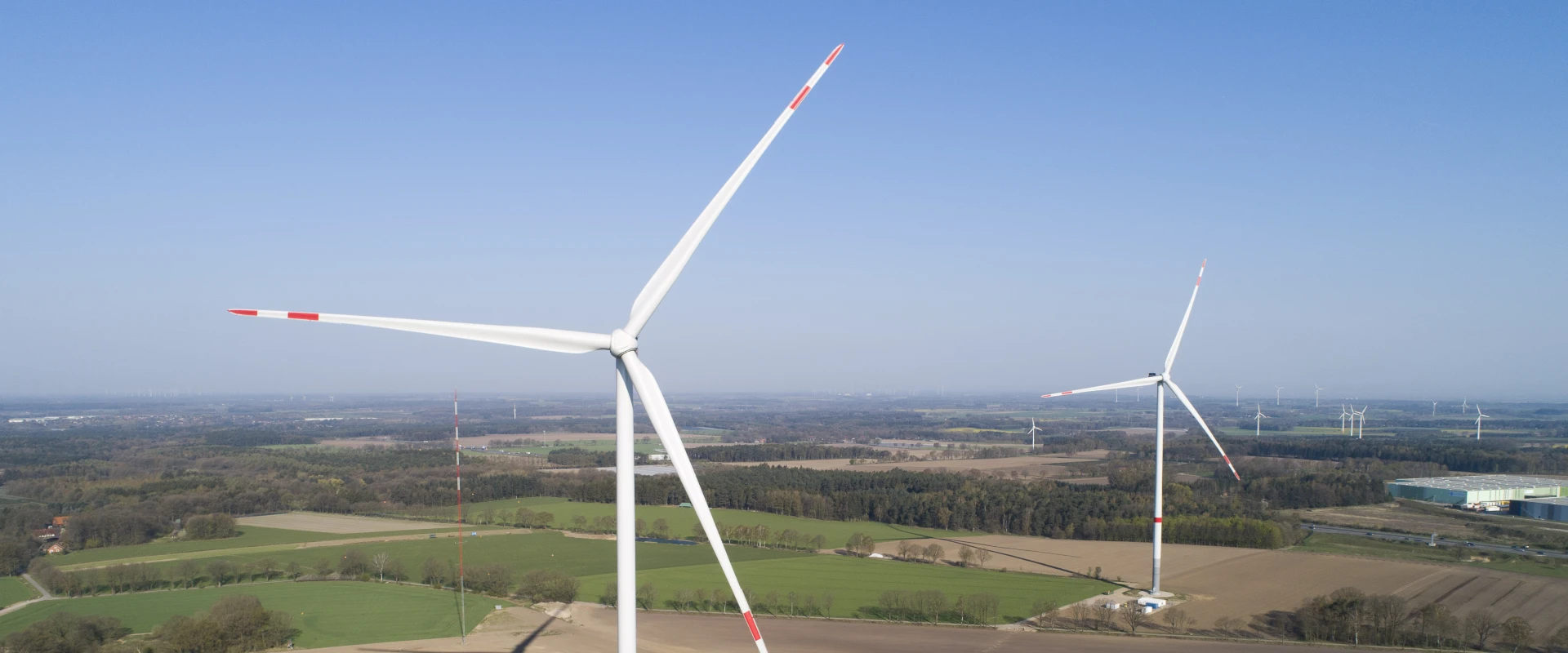 Aerial view of three wind turbines in a rural area