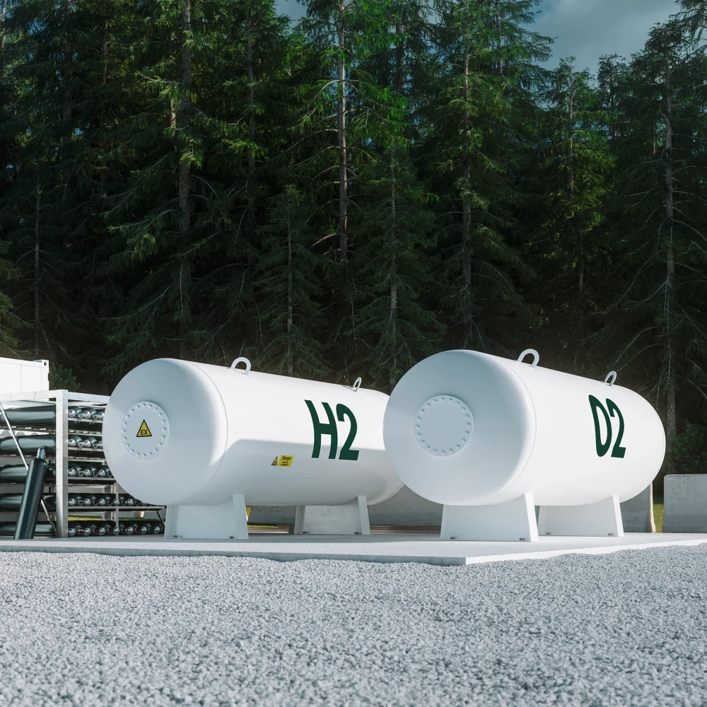 Two large white hydrogen tanks labeled H2 and D2 in front of a forest