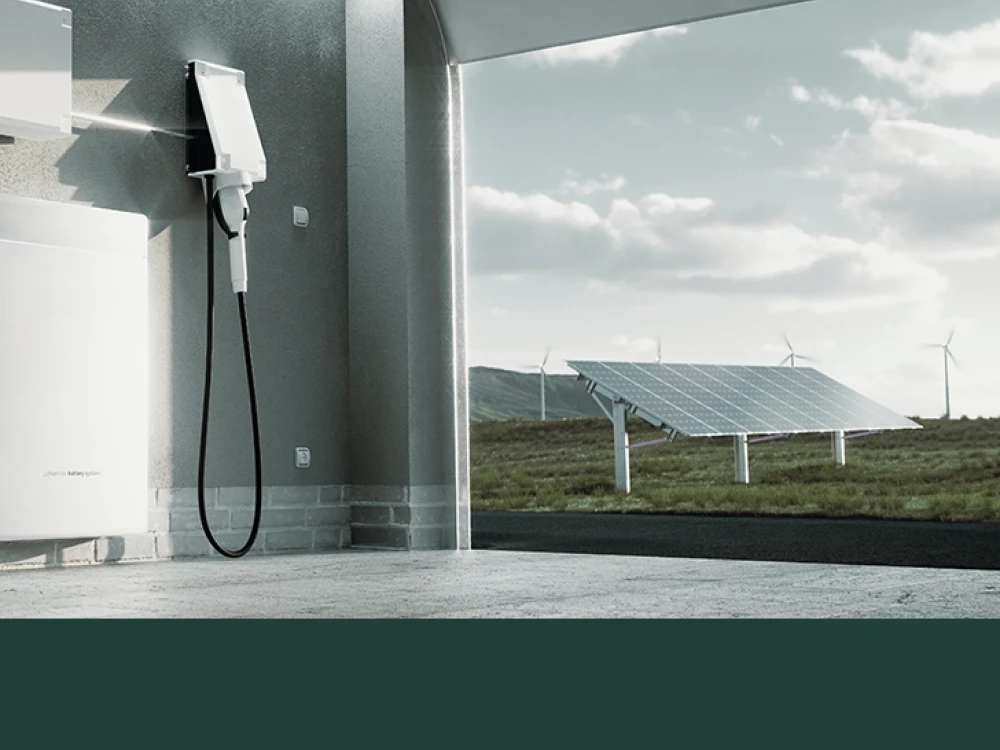 Electric vehicle charging station at a modern fuel station with solar panels and wind turbines in the background